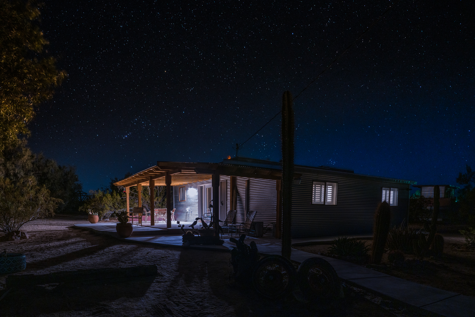 homestead with covered patios at night with clear night skies and stars above