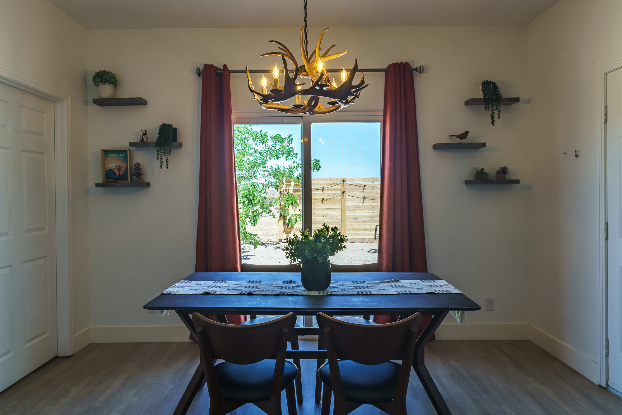 Dining Room with a view of the outdoors through the sliding glass door.