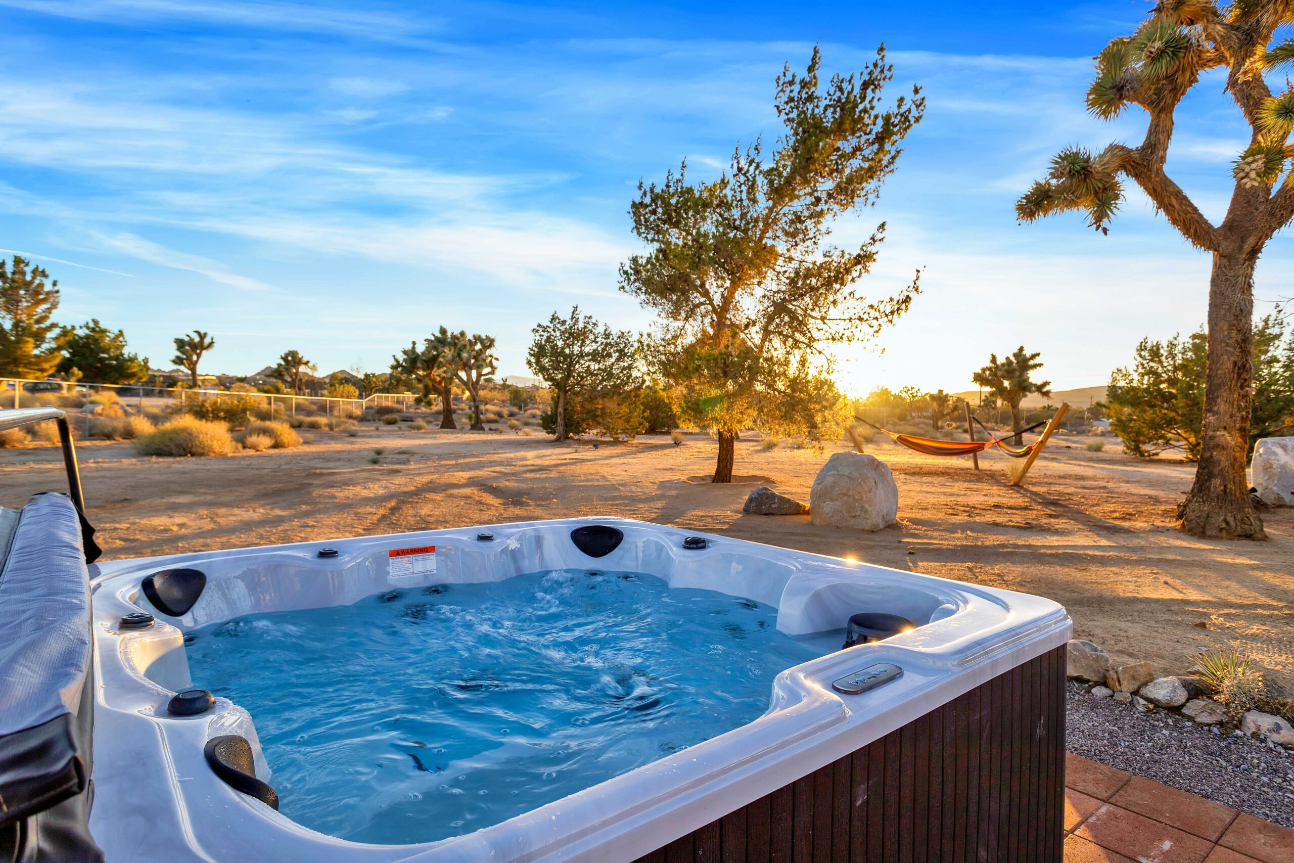 Hot tub in the backyard of a desert home at sunset
