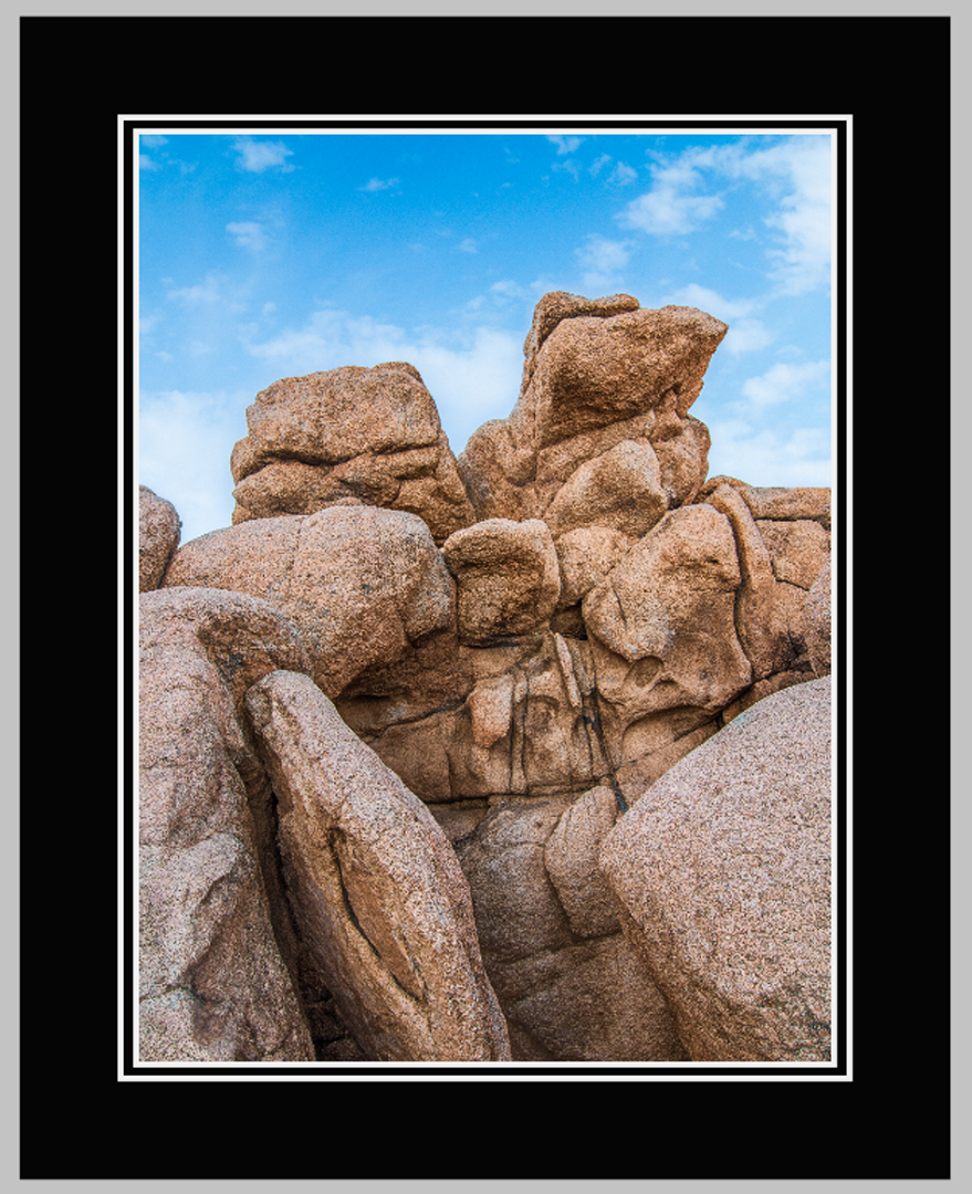 Rock Formations in Joshua Tree National Park Resembling Two Faces Side by Side, Often Compared to the “grumpy Old Men” Balcony Characters from the Muppet Show, Under a Blue Winter Sky.